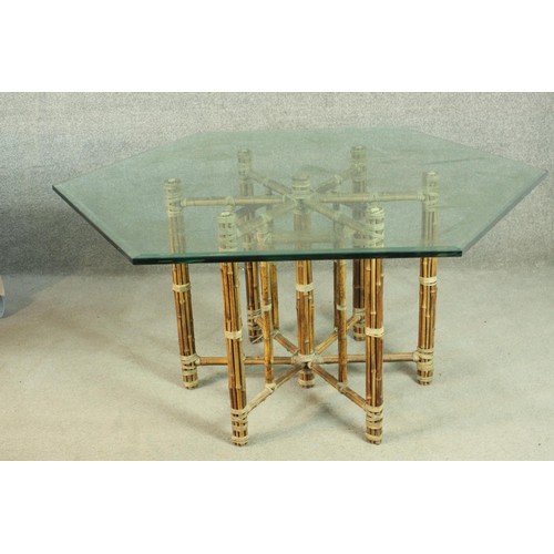 148 - A hexagonal bamboo dining table, with a plate glass top, the base formed of lashed bamboo. H.73 W.13... 