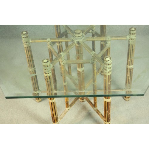148 - A hexagonal bamboo dining table, with a plate glass top, the base formed of lashed bamboo. H.73 W.13... 