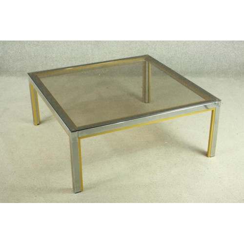 149 - Manner of Janetti, a 1970's coffee table, with a tinted glass coffee top on a chrome and brass frame... 