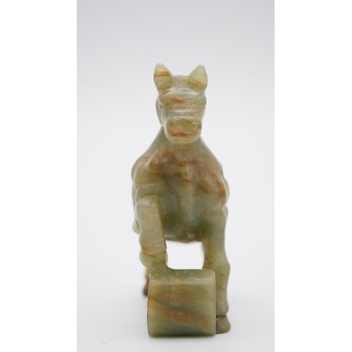 395 - A Chinese carved Jade horse on scroll base. H.11 W.11 D.3cm