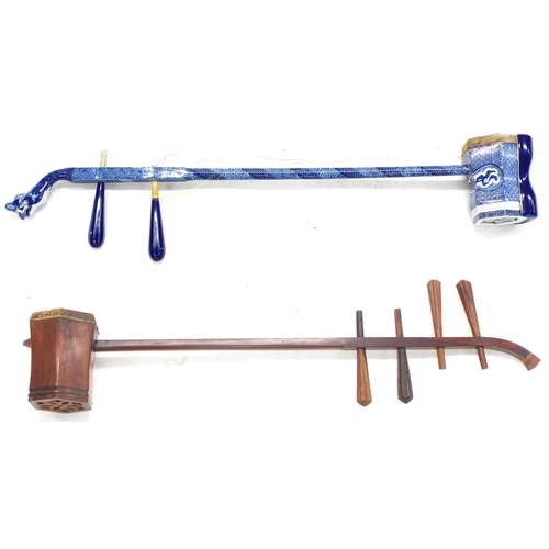 1245 - Decorative Chinese blue and white two string erhu fiddle; together with a similar four string fiddle... 