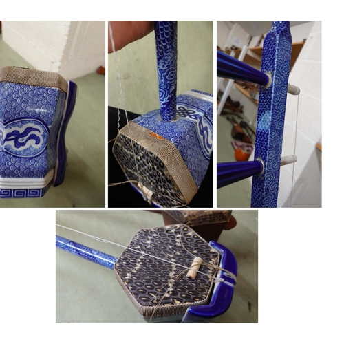 1245 - Decorative Chinese blue and white two string erhu fiddle; together with a similar four string fiddle... 