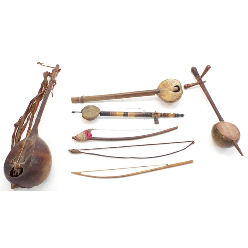 1252 - Four various antique and later African and other folk fiddles; together with three various folk fidd... 