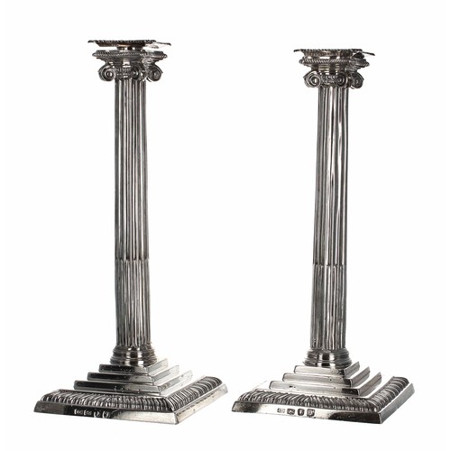 515 - Pair of George III silver candlesticks, modelled as Corinthian reeded columns on stepped square base... 