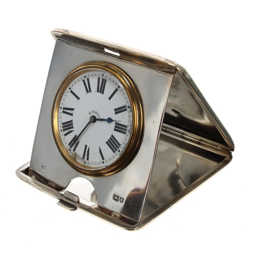532 - George V folding silver cased travelling eight day clock, within an engine turned cigarette case, Co... 