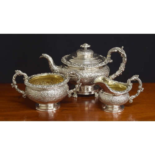 Fine William IV three piece silver tea set, densely repousse decorated with flowers within C scroll borders, with gilt interiors to the jug and bowl, maker John & Thomas Settle, Sheffield 1820, teapot 7.25" high, 52oz t (3)