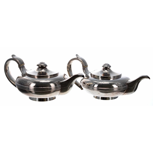 550 - Pair of George IV silver teapots of compressed form, with capped handles and single reeded bodies, e... 
