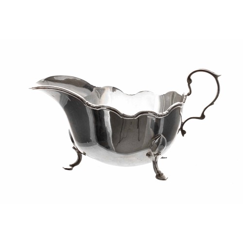 519 - Frank Cobb & Co. silver sauce boat, with moulded scrolling rim and capped C-scroll handle, raise... 