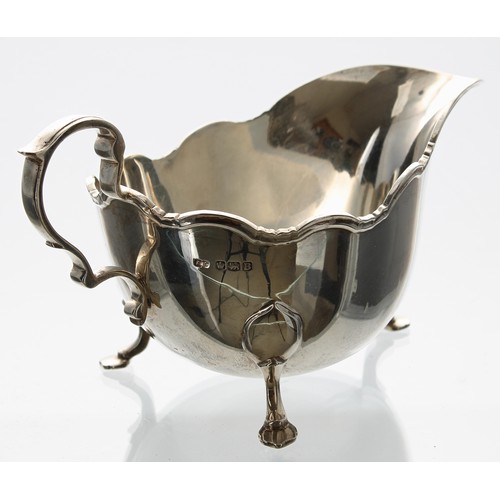 519 - Frank Cobb & Co. silver sauce boat, with moulded scrolling rim and capped C-scroll handle, raise... 