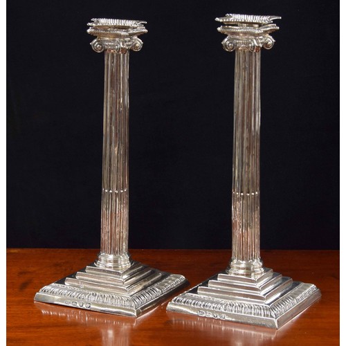 515 - Pair of George III silver candlesticks, modelled as Corinthian reeded columns on stepped square base... 
