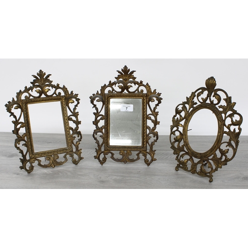 7 - Pair of French rococo gilt metal strut frames, with elaborate scrolling foliate surrounds, one conta... 
