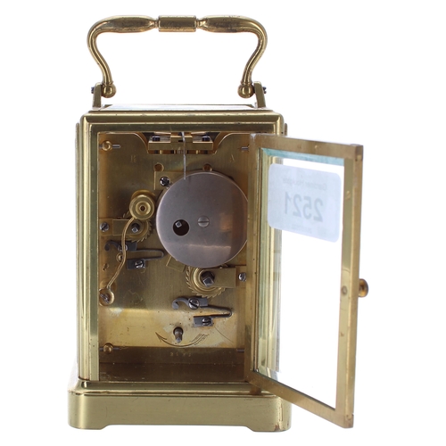 Small carriage clock timepiece with alarm sounding on a bell, within a