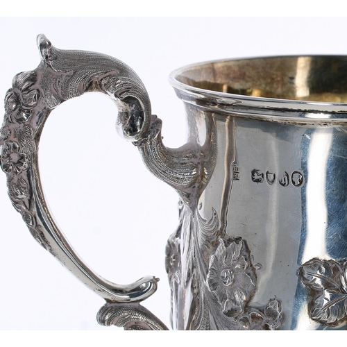502 - Attractive Victorian repousse silver pedestal christening mug, with foliate swags and C scroll handl... 