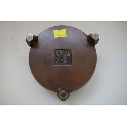 509 - A Chinese bronze tripod censer, four character mark, on mask feet, 15cm diameter, 1913g.... 