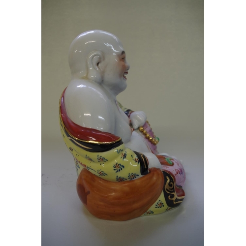 510 - A Chinese famille rose buddha, 24cm high.
