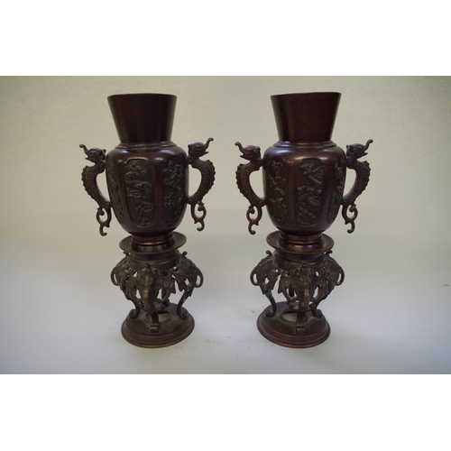 517 - A pair of Chinese bronze twin handled vases, 19th century, 25.5cm high.