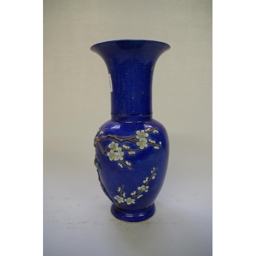 521 - A Chinese blue ground vase, late 19th century, relief decorated with a bird in a flowering prunus tr... 