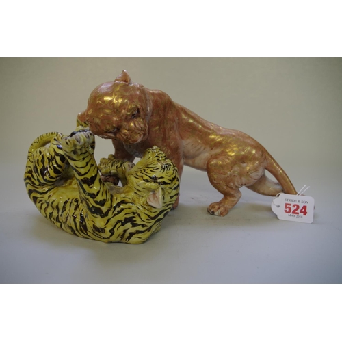 524 - A Japanese porcelain figure group of two fighting tigers, probably Meiji period, 32cm wide... 