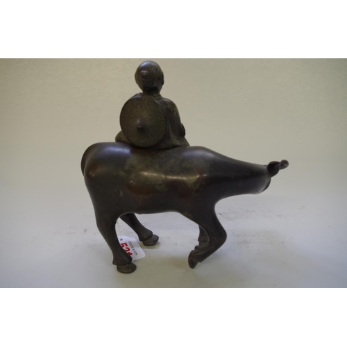 531 - A Chinese bronze buffalo censer and figural cover, 17cm high.