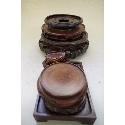 540 - A collection of seven Chinese hardwood stands, apertures of largest two: 16cm and 12.5cm. (7)... 