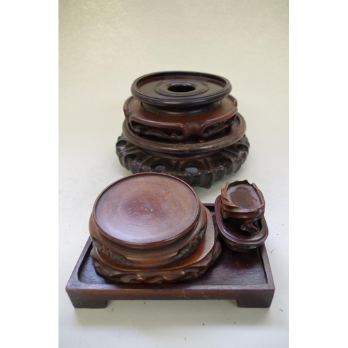 540 - A collection of seven Chinese hardwood stands, apertures of largest two: 16cm and 12.5cm. (7)... 
