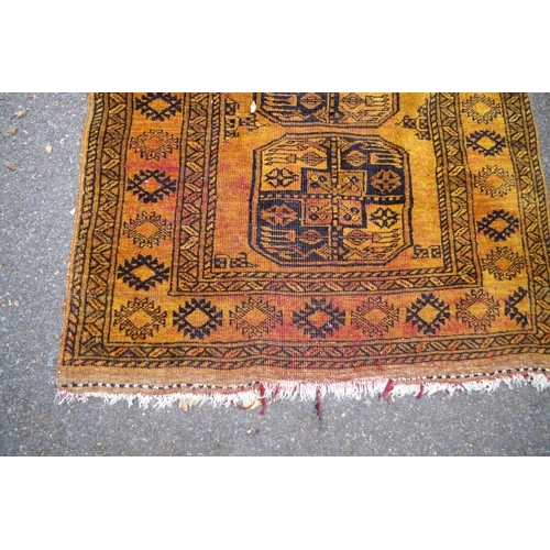 1236 - An old Bokhara rug, having three central medallions to central field, having allover geometric desig... 