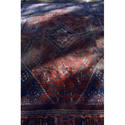 1241 - A large Persian rug, having central diamond medallion with allover floral central field, with g... 