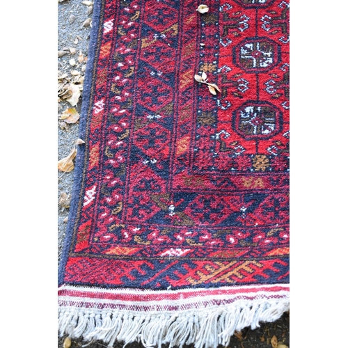 1242 - A Kayan runner, having red ground and geometric design allover, 290 x 85cm.