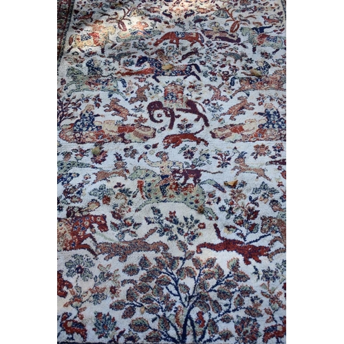1243 - A machine made rug, having floral decoration and animal motifs; together with another rug havin... 
