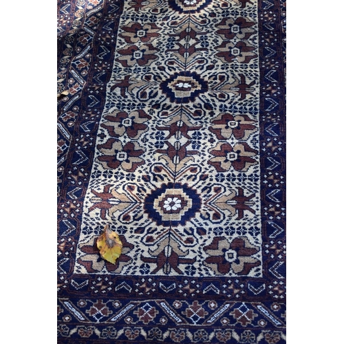 1244 - A modern Persian rug, having allover floral and geometric design, 205 x 110cm.