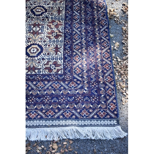 1244 - A modern Persian rug, having allover floral and geometric design, 205 x 110cm.
