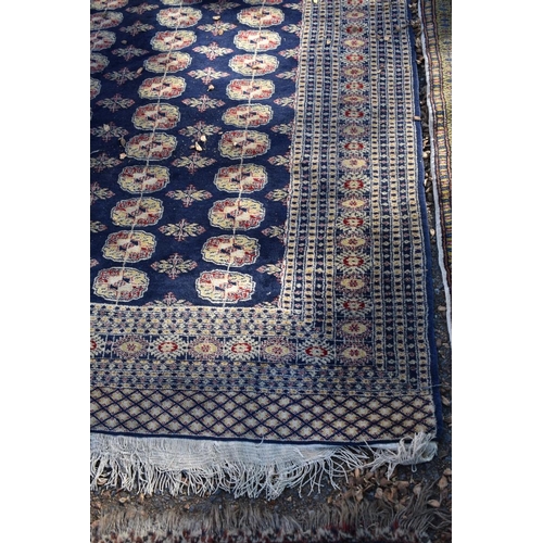 1247 - Two Bokhara style rugs; together with a similar green rug, largest 210 x 127cm.