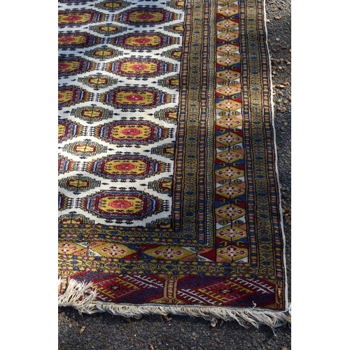 1247 - Two Bokhara style rugs; together with a similar green rug, largest 210 x 127cm.