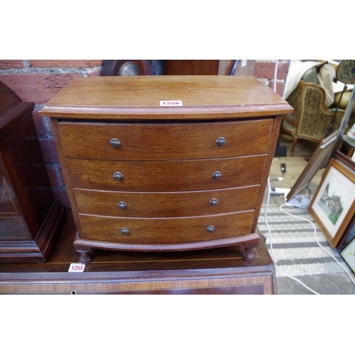 1256 - A miniature mahogany bowfront four drawer chest, 38cm wide.