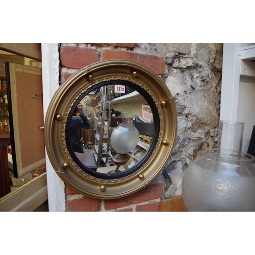 1372 - A reproduction gilt framed circular convex wall mirror, 42cm diameter.