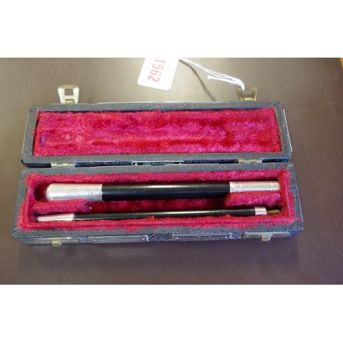 1562 - A silver mounted and ebonized conductor's baton, in two pieces, in a fitted case bearing various Chi... 
