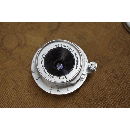 1717 - Cameras: a Leitz Summaron f=2.8cm 1:5.6 lens, with lens cap and Leitz brown leather box.... 
