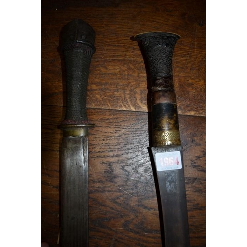 1964 - An antique sword, having 53cm blade and twisted wire grip; together with another eastern sword. (2)... 