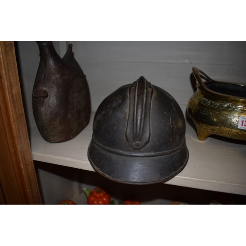 1353 - A French World War I M15 Adrian helmet; together with a similar metal bottle. (2)