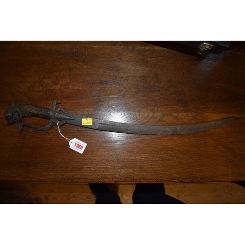 1966 - A 19th century Indonesian sword, having curved 49cm blade and carved wooden handle decorated dragon.... 