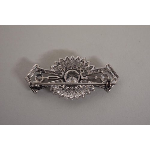 298 - An Art Deco old European cut diamond brooch, the central stone of approximately 2ct, flanked by two ... 