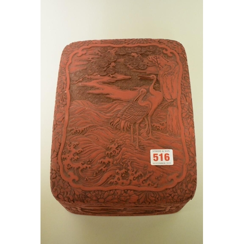 516 - A cinnabar lacquer rectangular box and cover, relief decorated with cranes, 27cm wide.... 