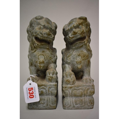 530 - A pair of Chinese green jade or soapstone lion dogs, 21.5cm high. (2)