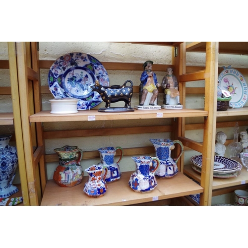 1023 - A collection of Victorian and later pottery, to include Mason's jugs. (two shelves)