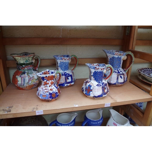 1023 - A collection of Victorian and later pottery, to include Mason's jugs. (two shelves)