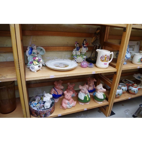 1025 - A mixed group of pottery and porcelain, to include Nat West piggy banks. (two shelves)... 