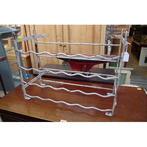 1042 - An antique white painted wrought iron rack, possibly for wine, 57cm wide.