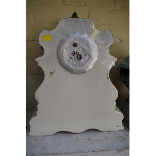 1079 - An old pottery mantel timepiece, 42cm high.