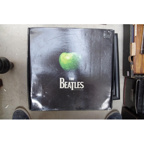 1114 - A small collection of Beatles memorabilia, to include: 33rpm albums; books; and a framed presen... 