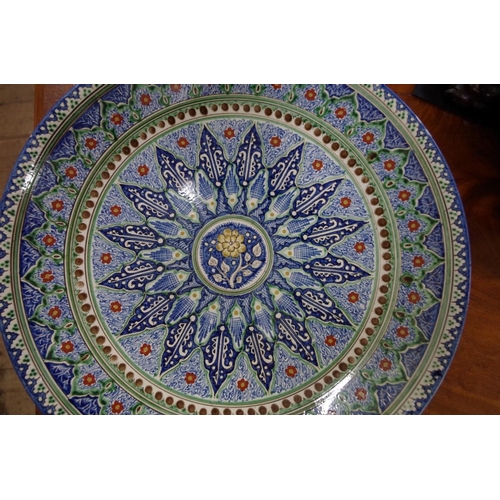 1257 - An Iznik style pottery charger, initialled 'BA' to base, 40.5cm diameter.